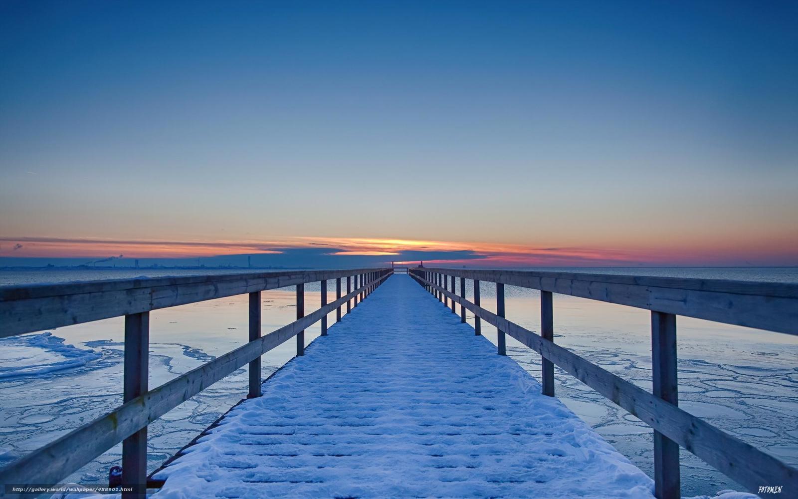 Snowy pier at sunset
