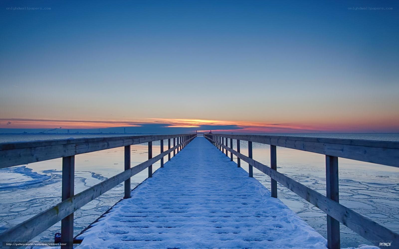 Snowy pier at sunset