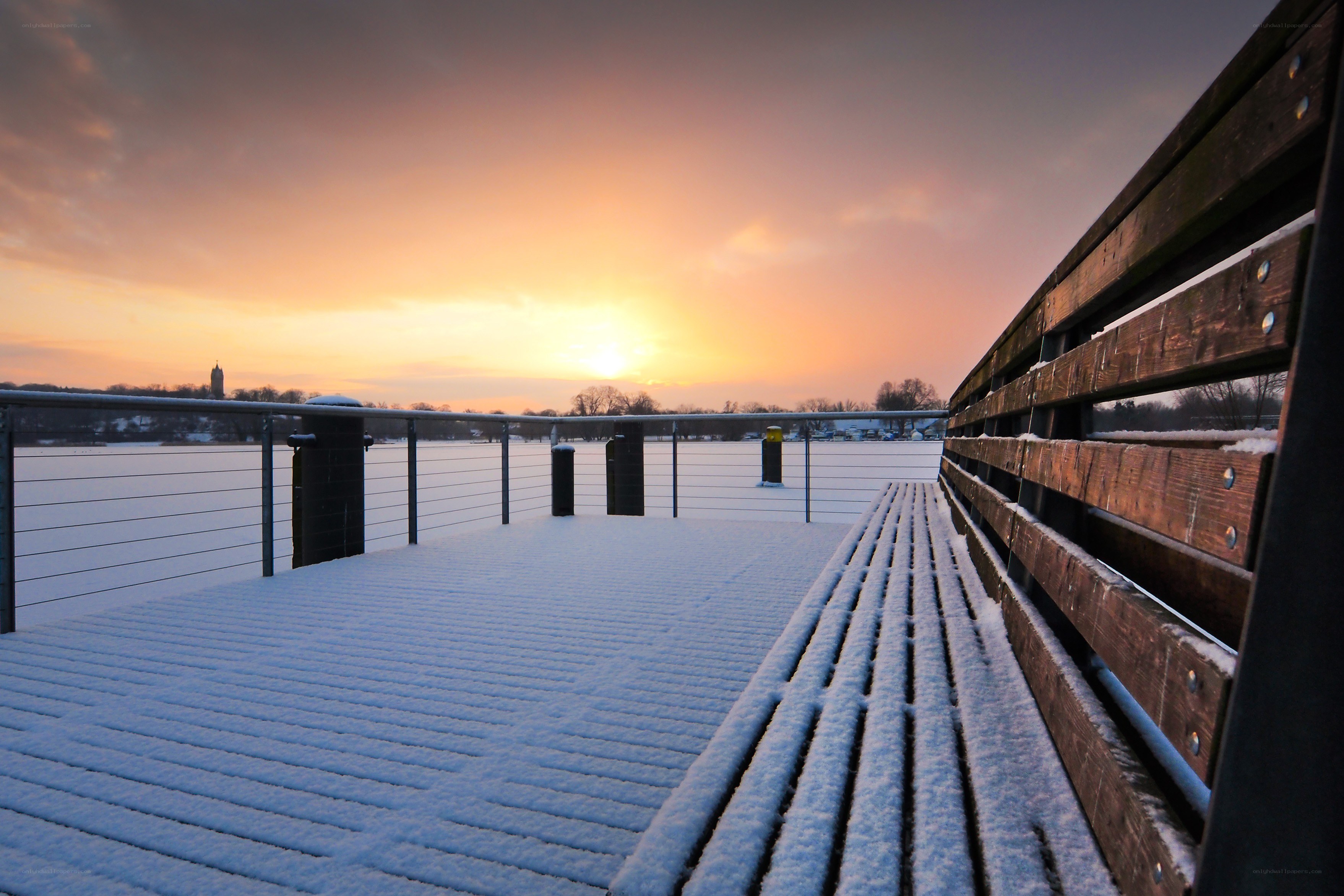 Snowy pier at sunset