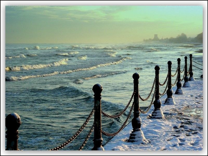 Snowy pier at the ocean