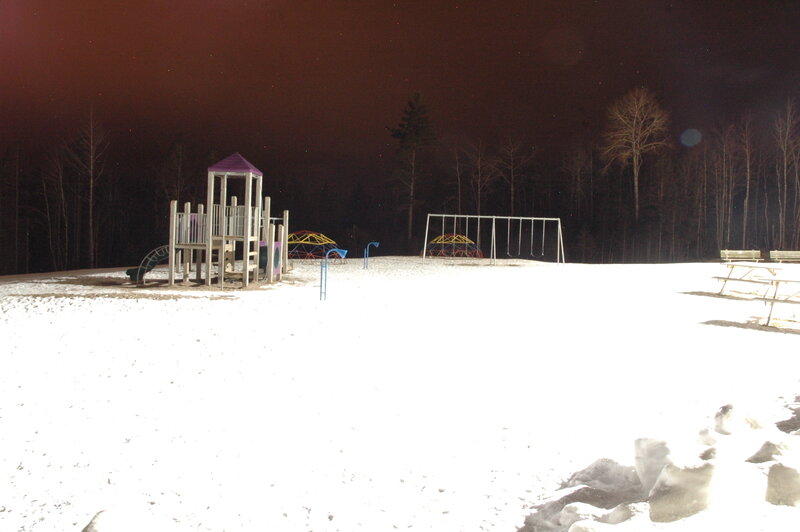 snowy playground at night