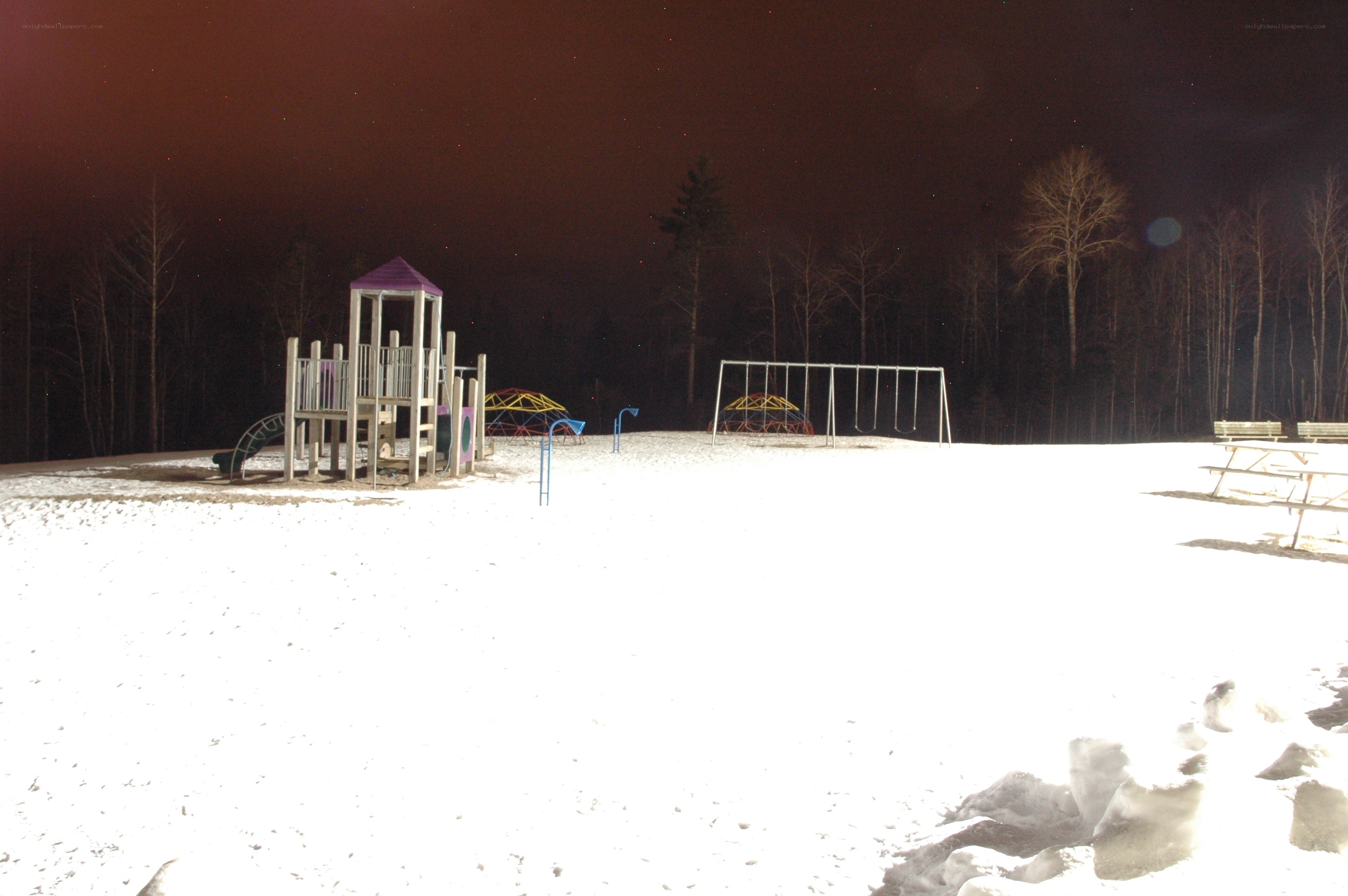 snowy playground at night