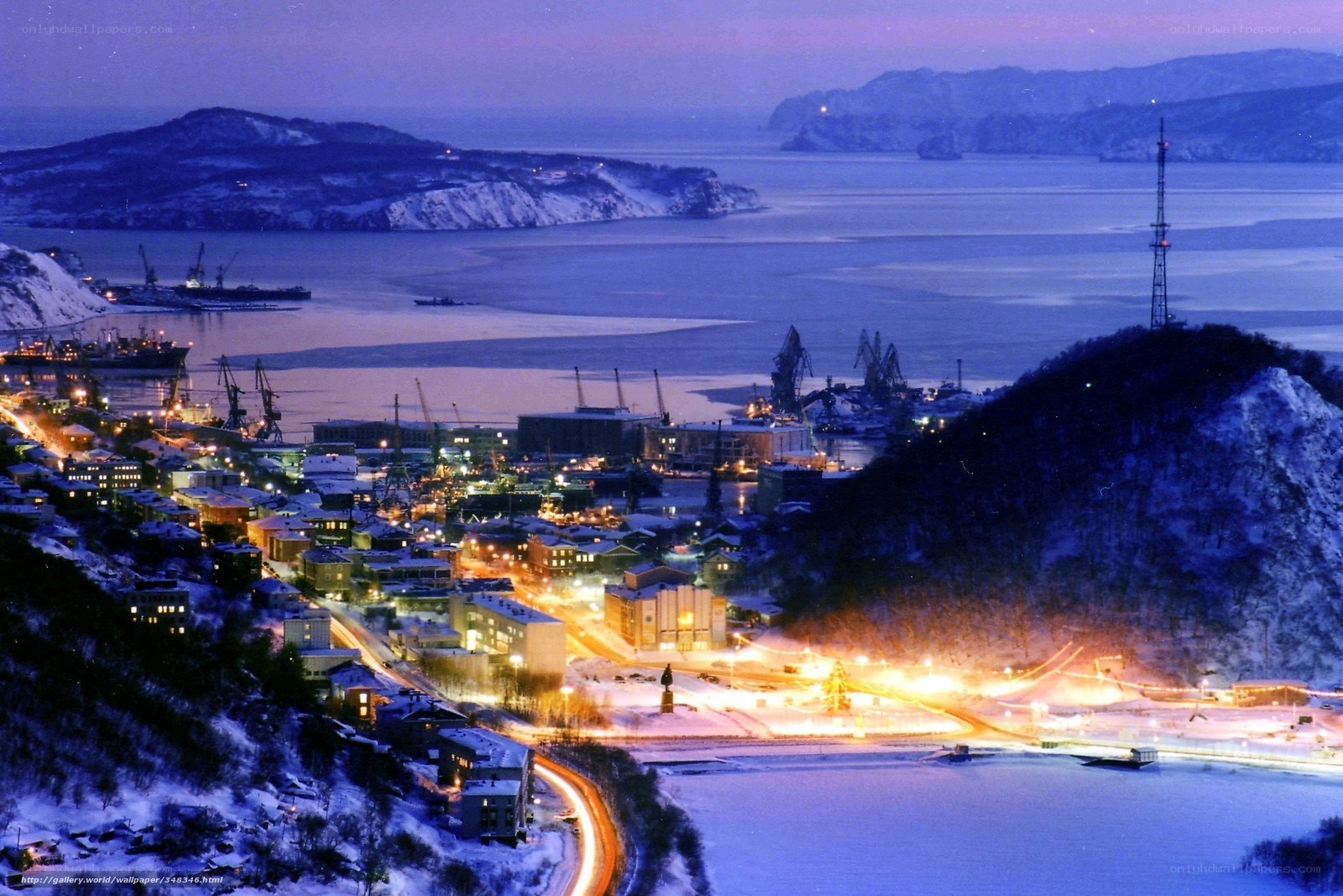 Snowy port city at dusk