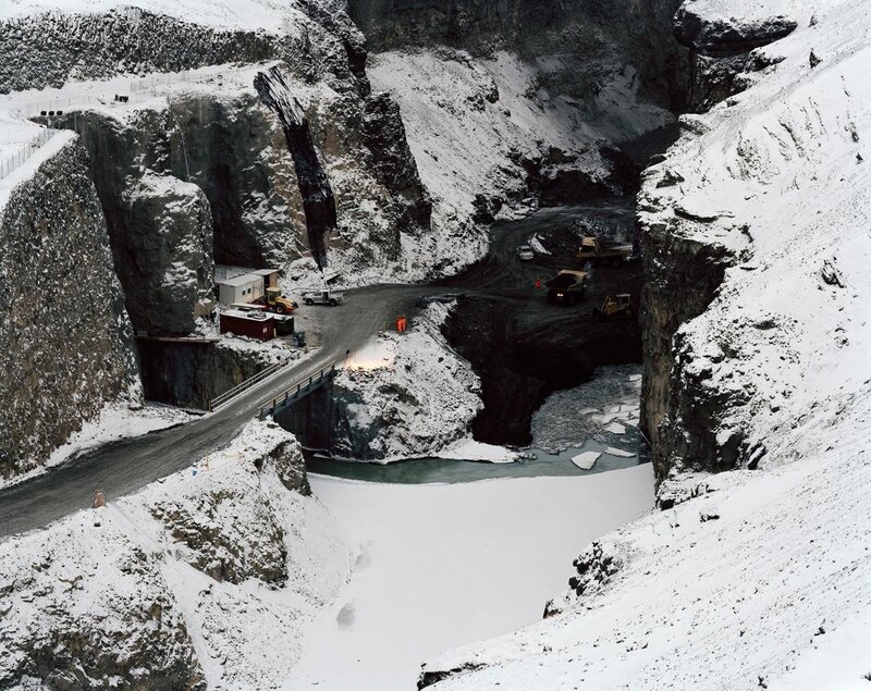 Snowy quarry with heavy machinery