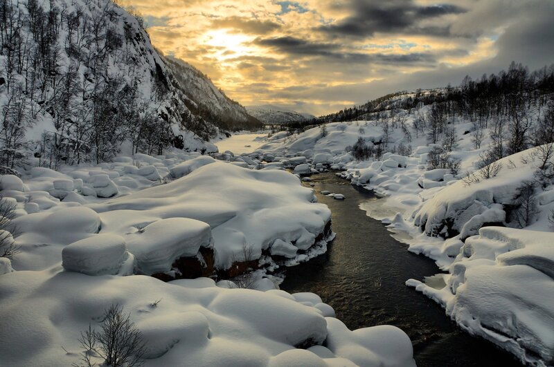Snowy river at sunset