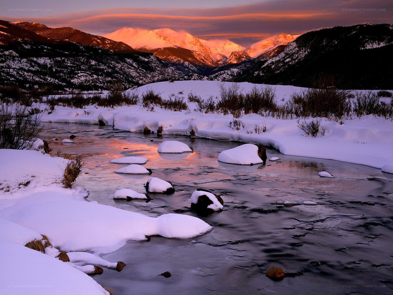 Snowy river at sunset in mountains