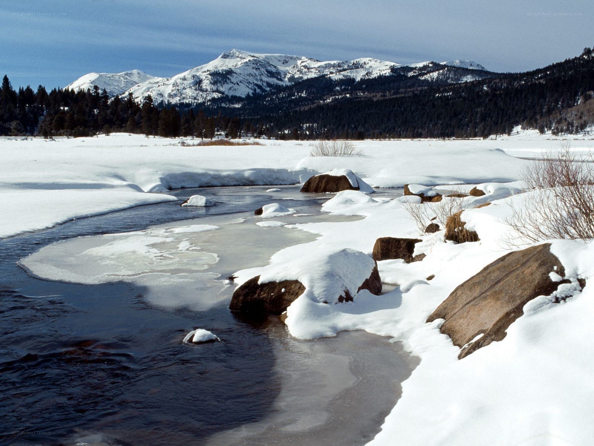 Snowy river in mountain landscape