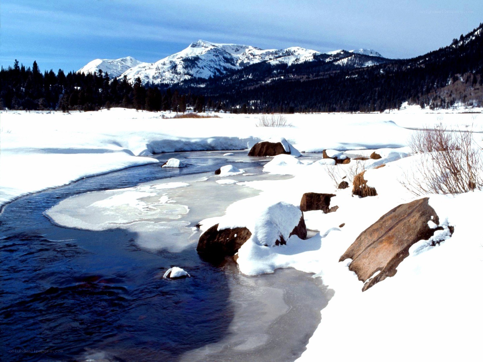 Snowy river in mountain landscape