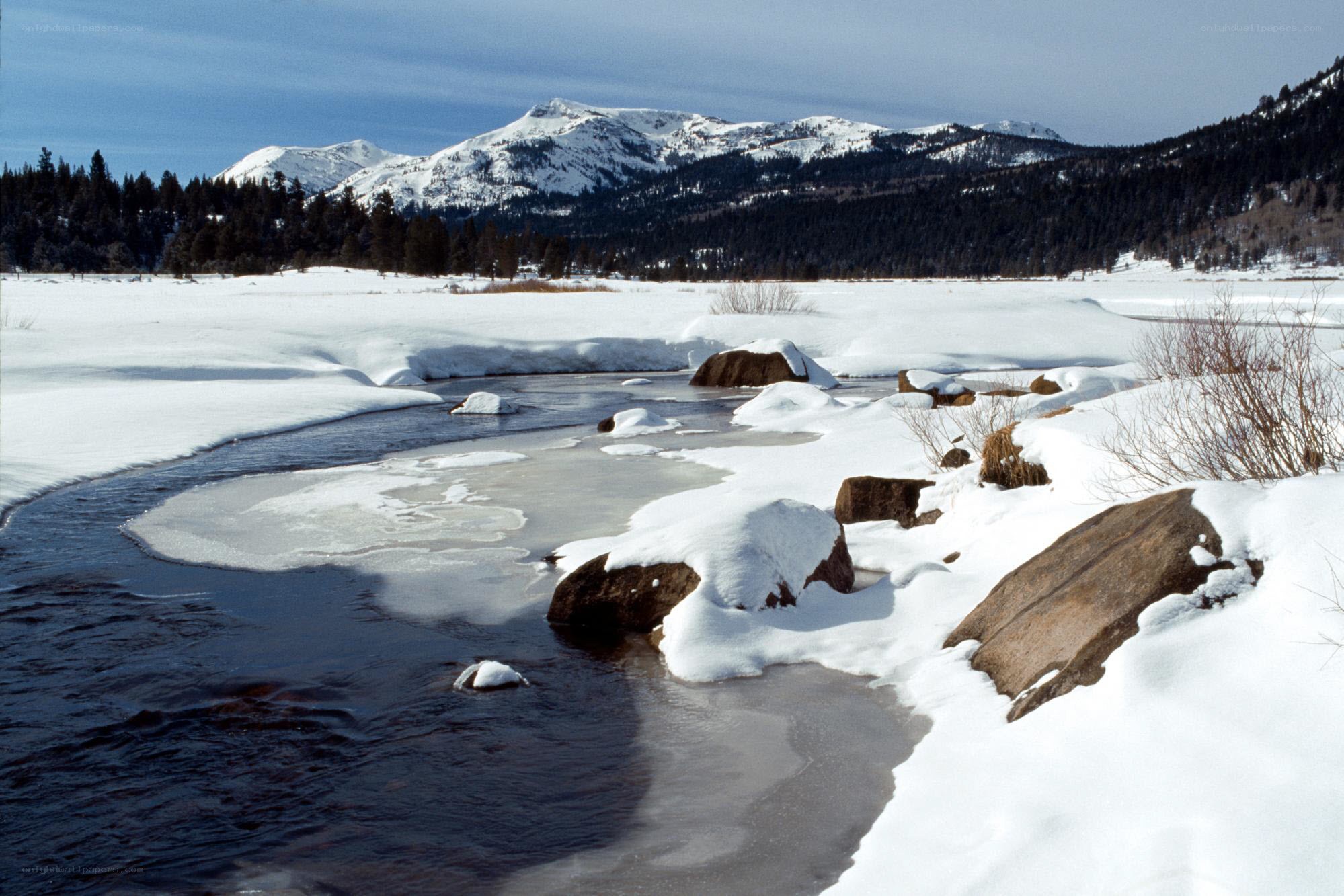 Snowy river in mountain valley