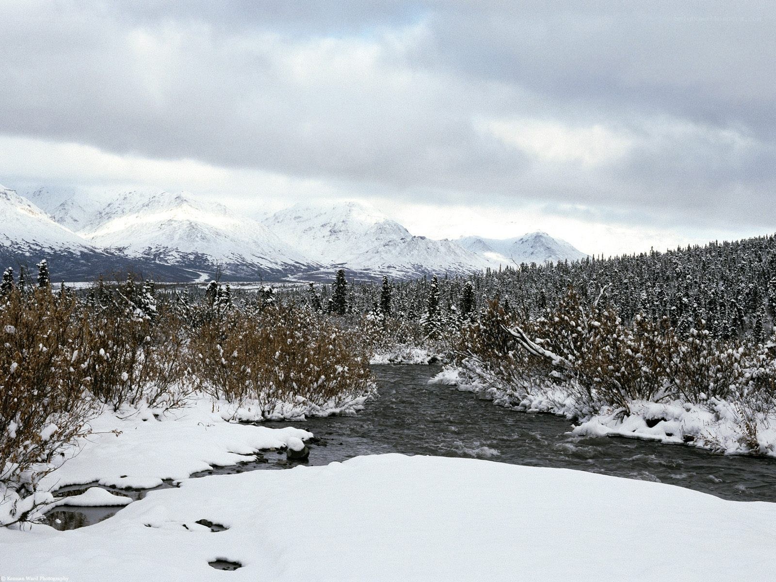 Snowy river in mountain valley