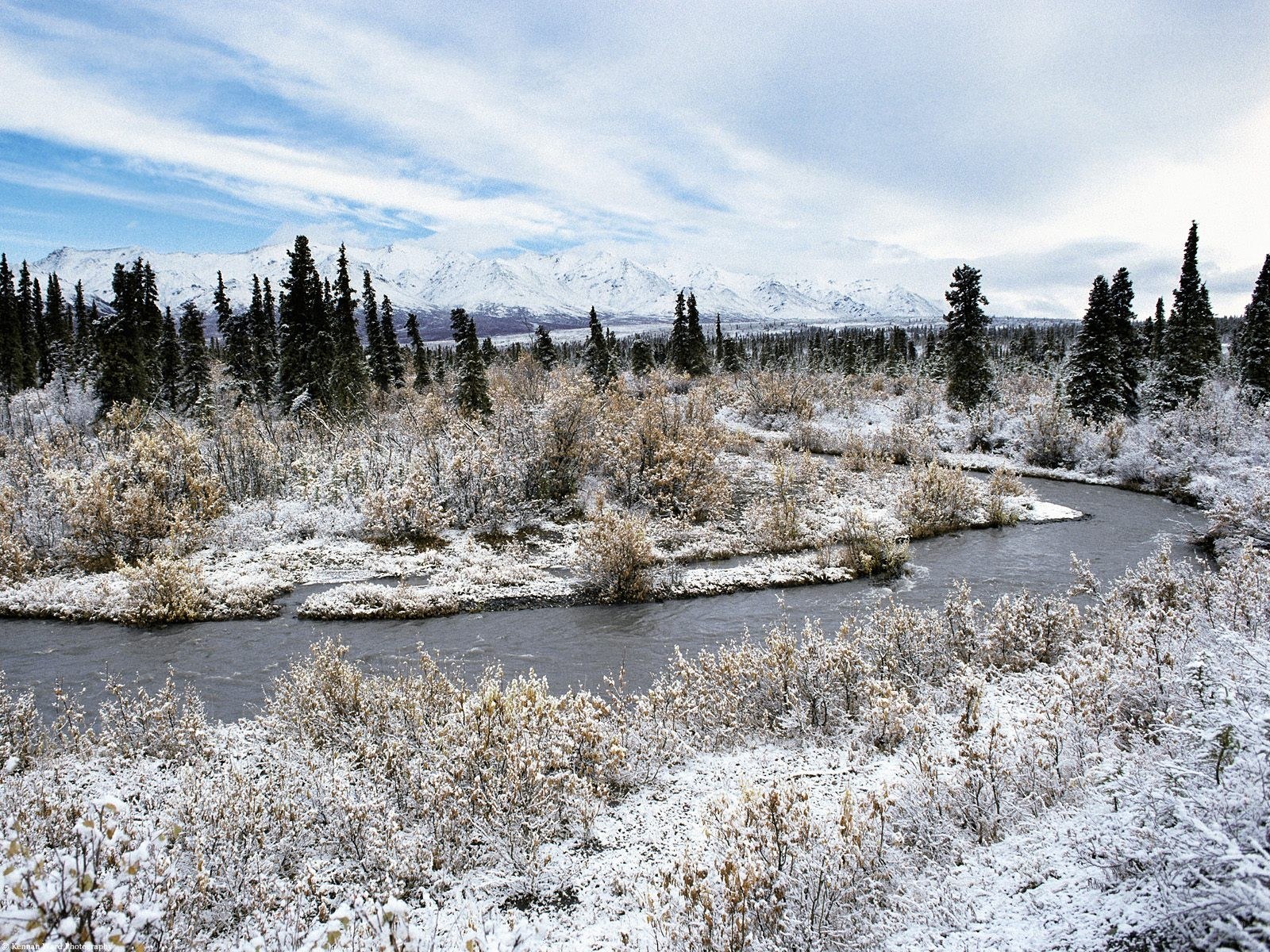 Snowy river in mountain valley