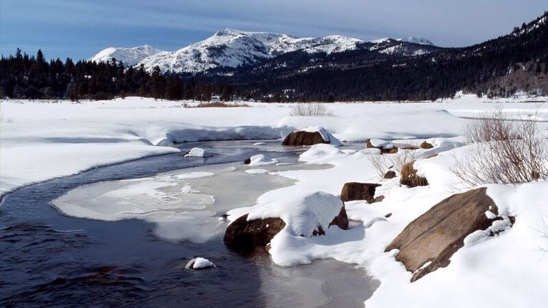 Snowy river in mountain valley