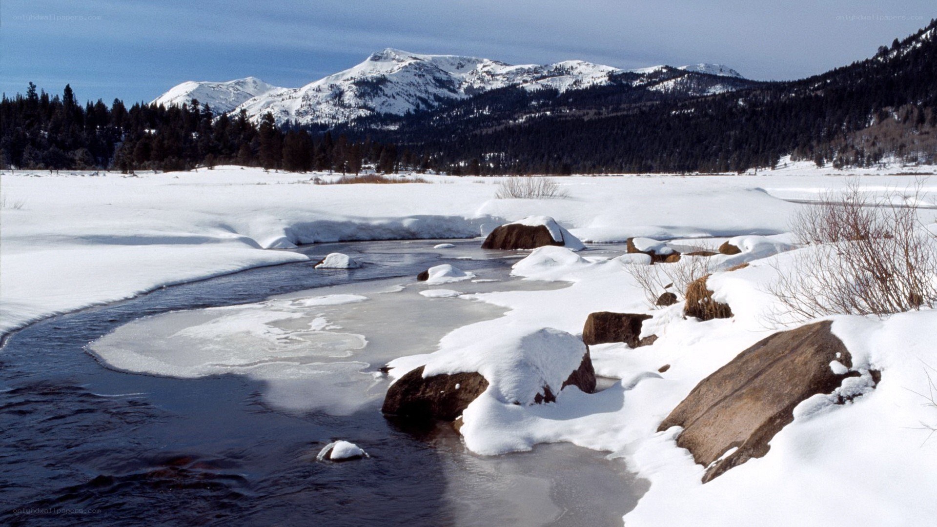 Snowy river in mountain valley