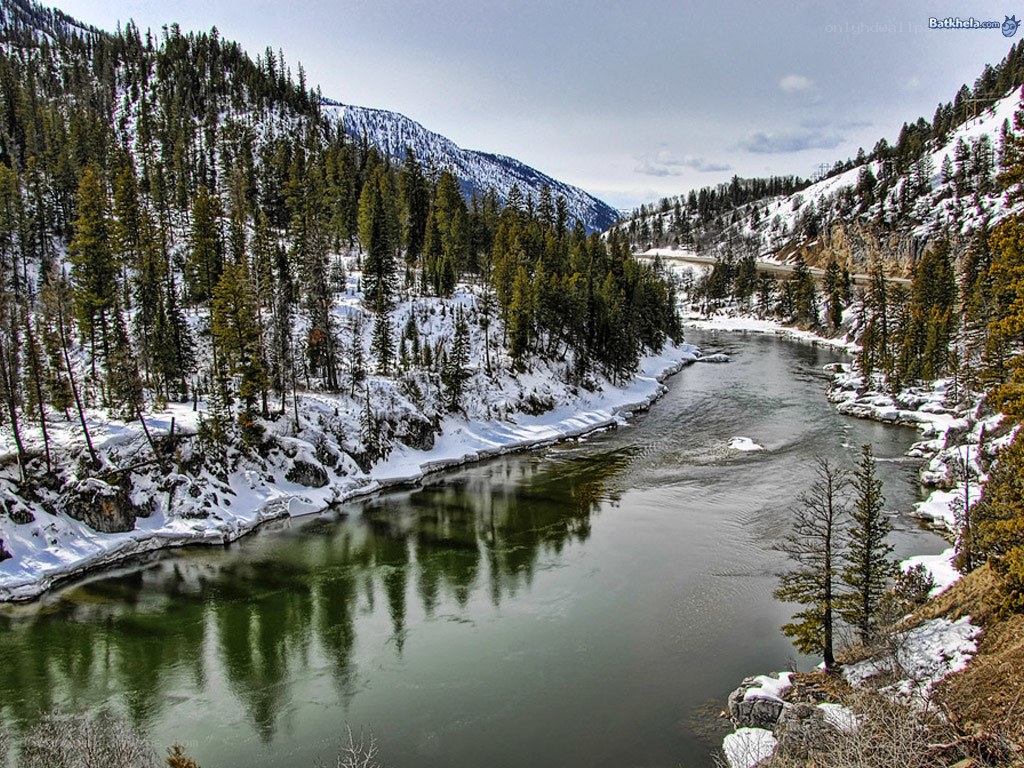 Snowy river in mountain valley