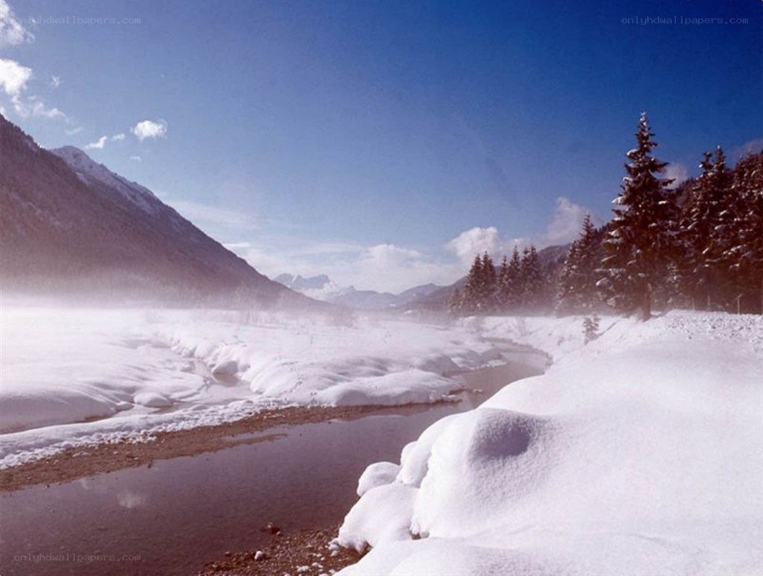 Snowy river in mountain valley