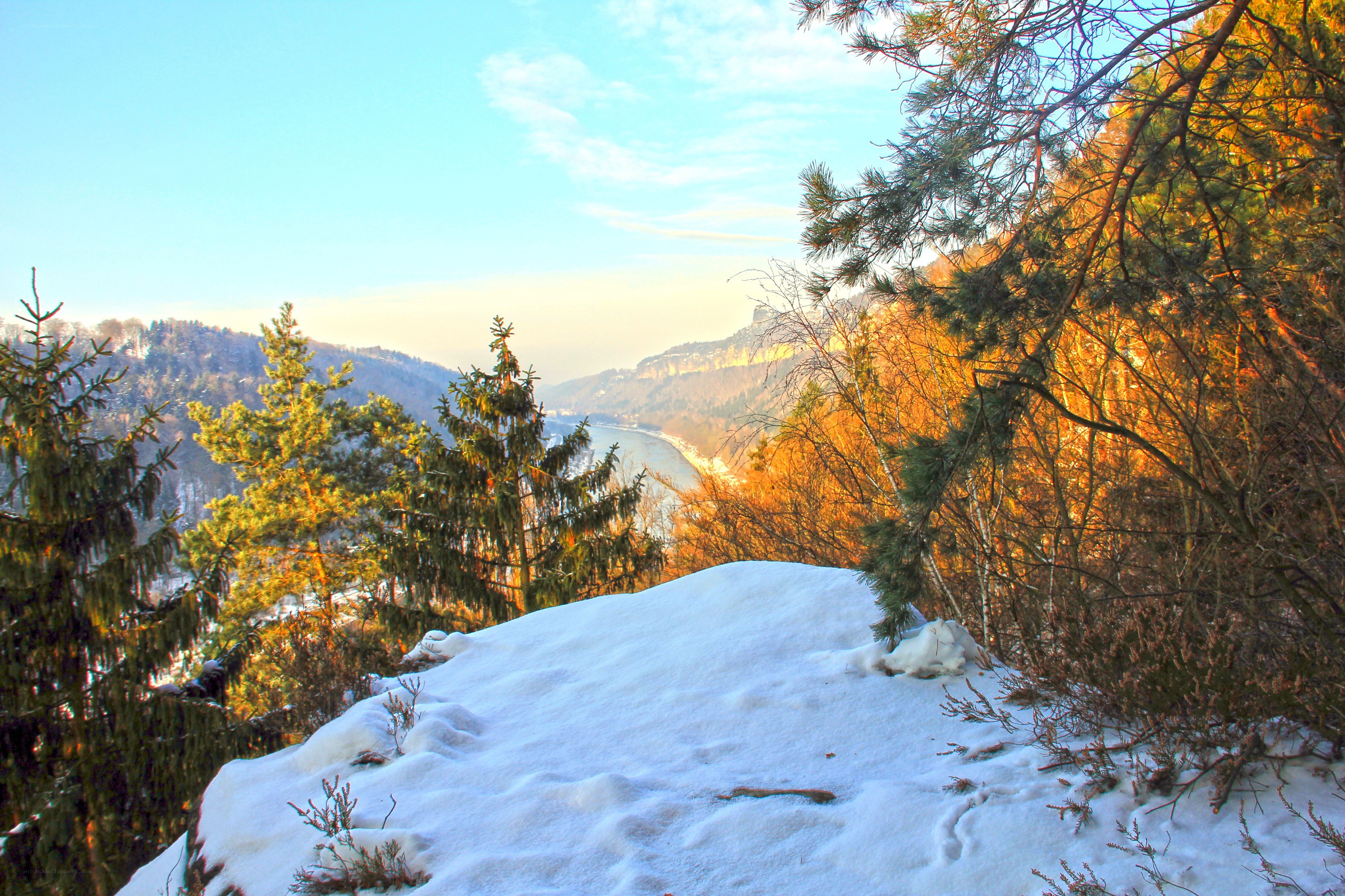 Snowy river valley at sunset