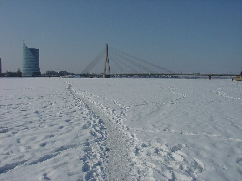 Snowy river with bridge and building