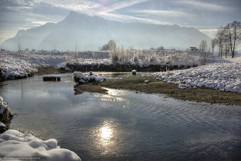 Snowy river with mountain backdrop