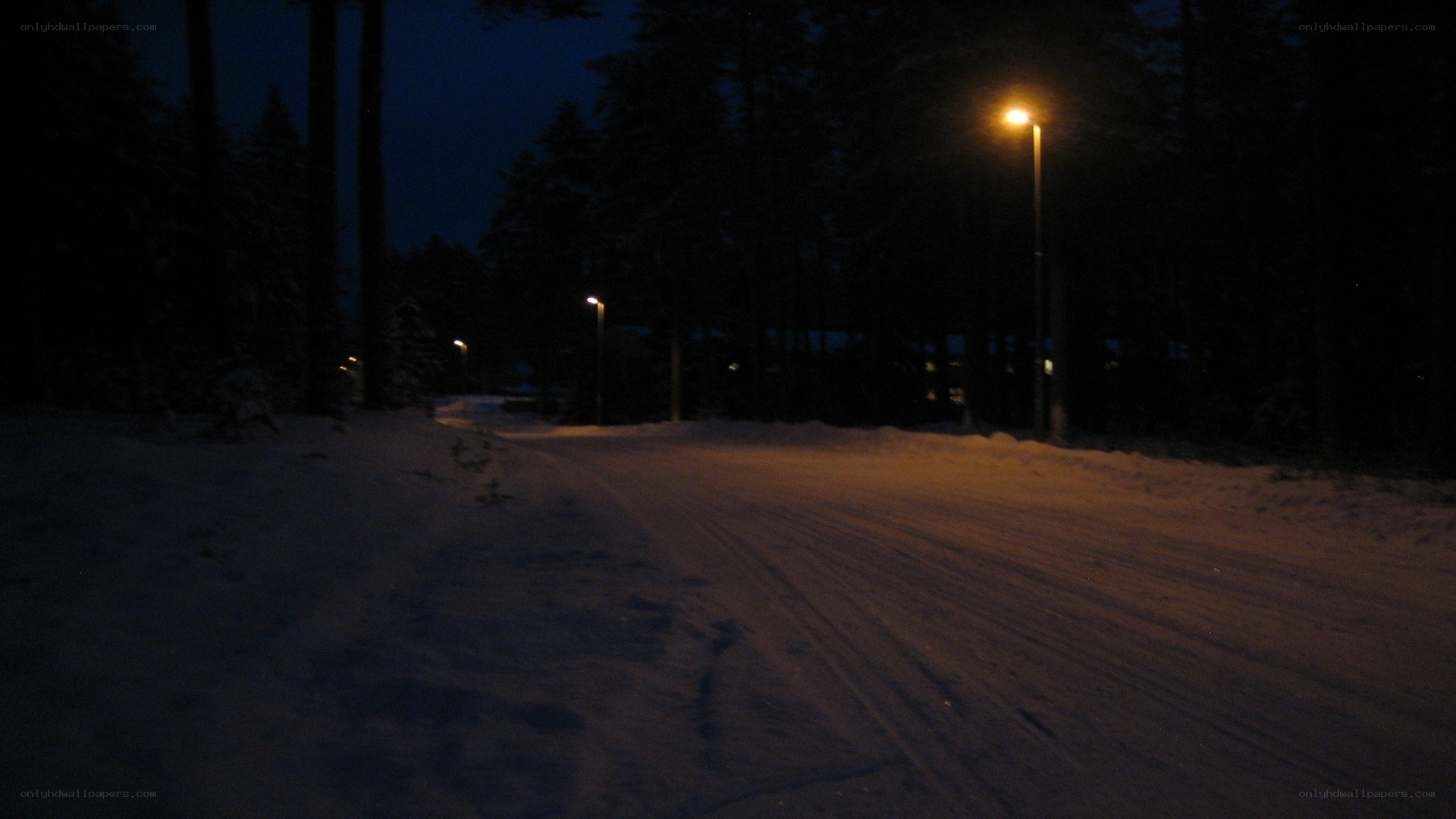 Snowy road at night