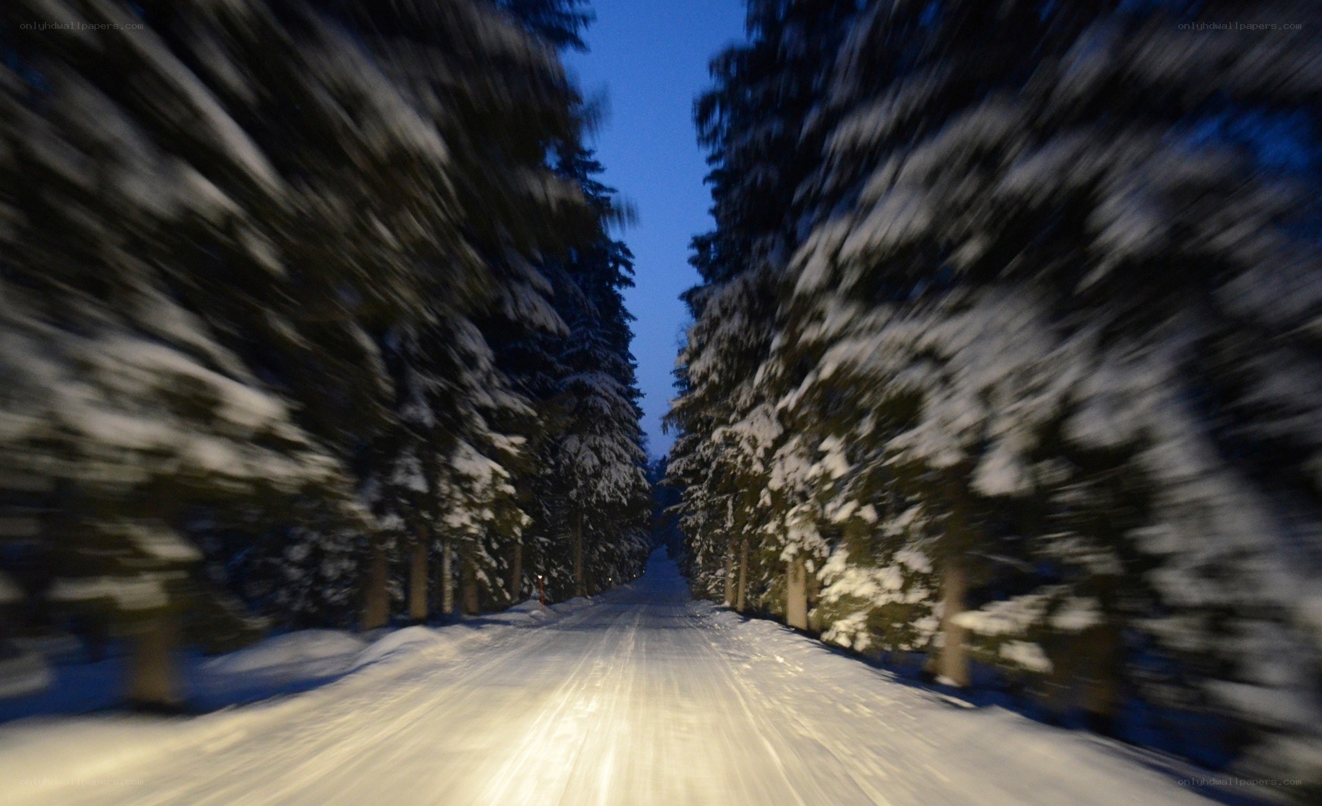 Snowy road at night