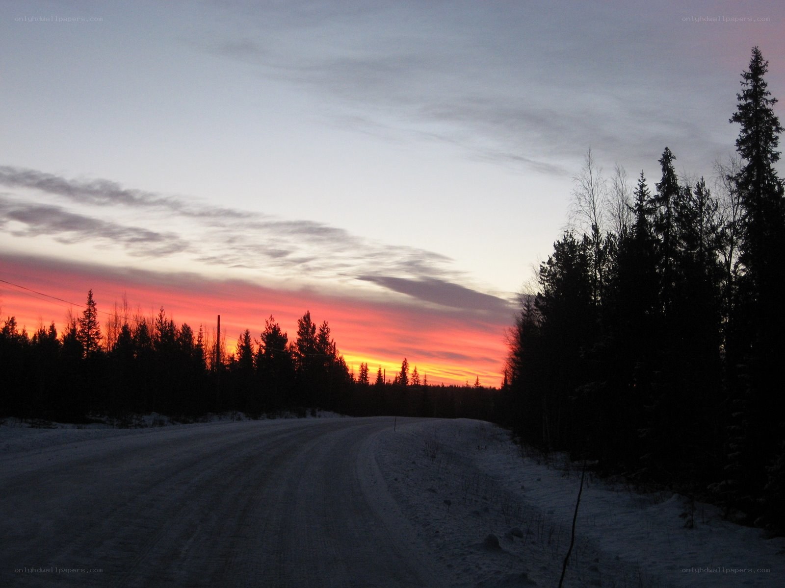 Snowy road at sunset