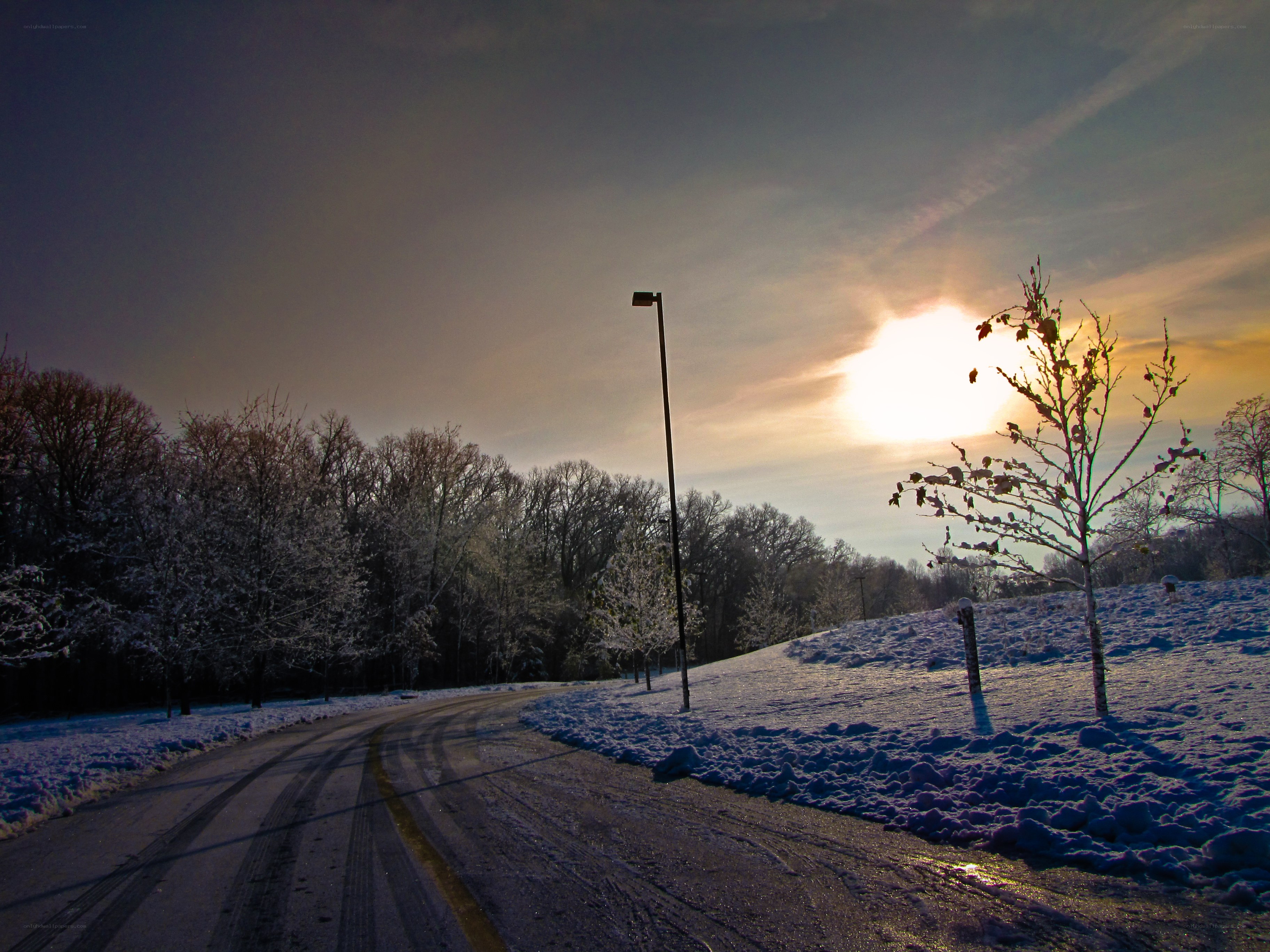 Snowy road at sunset