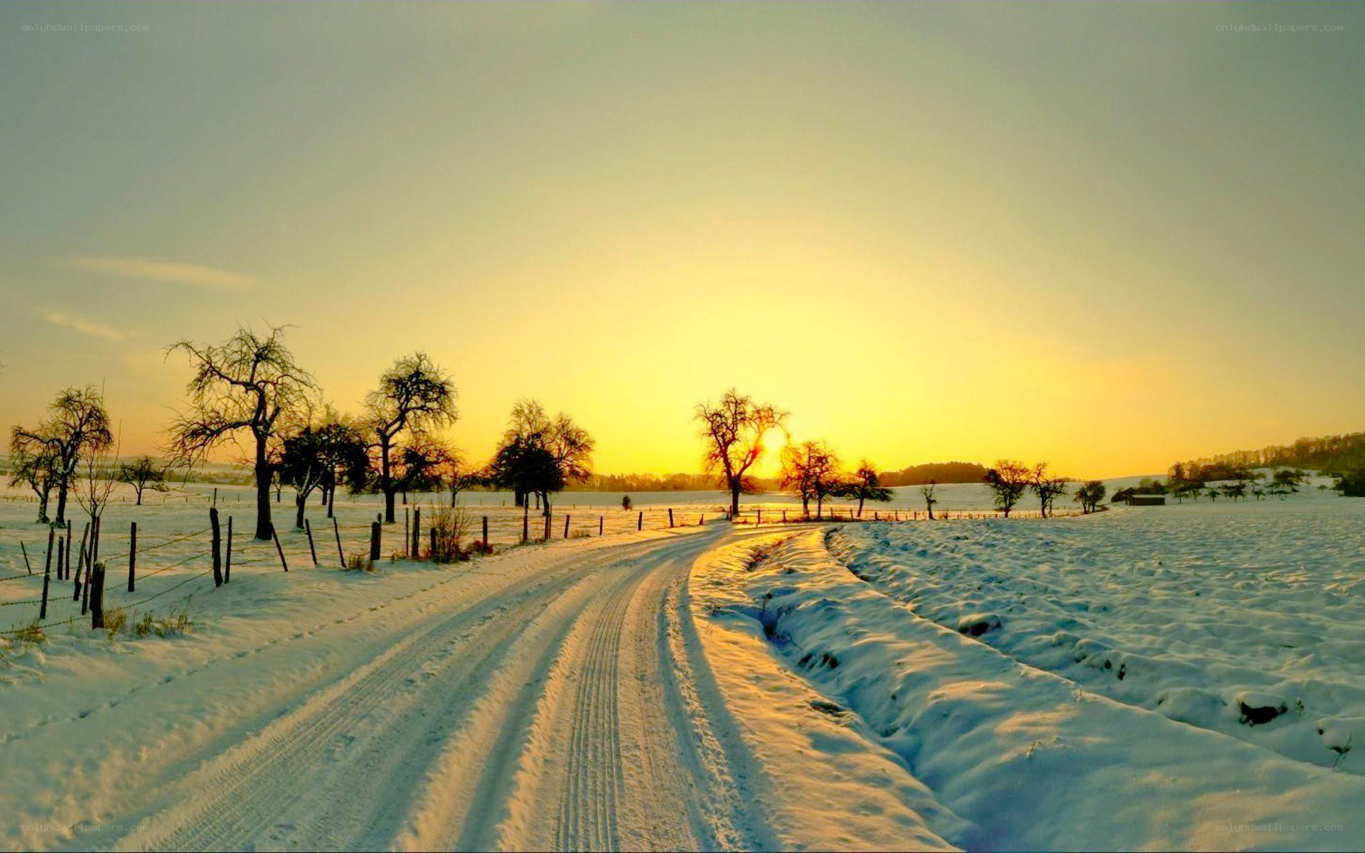 Snowy road at sunset