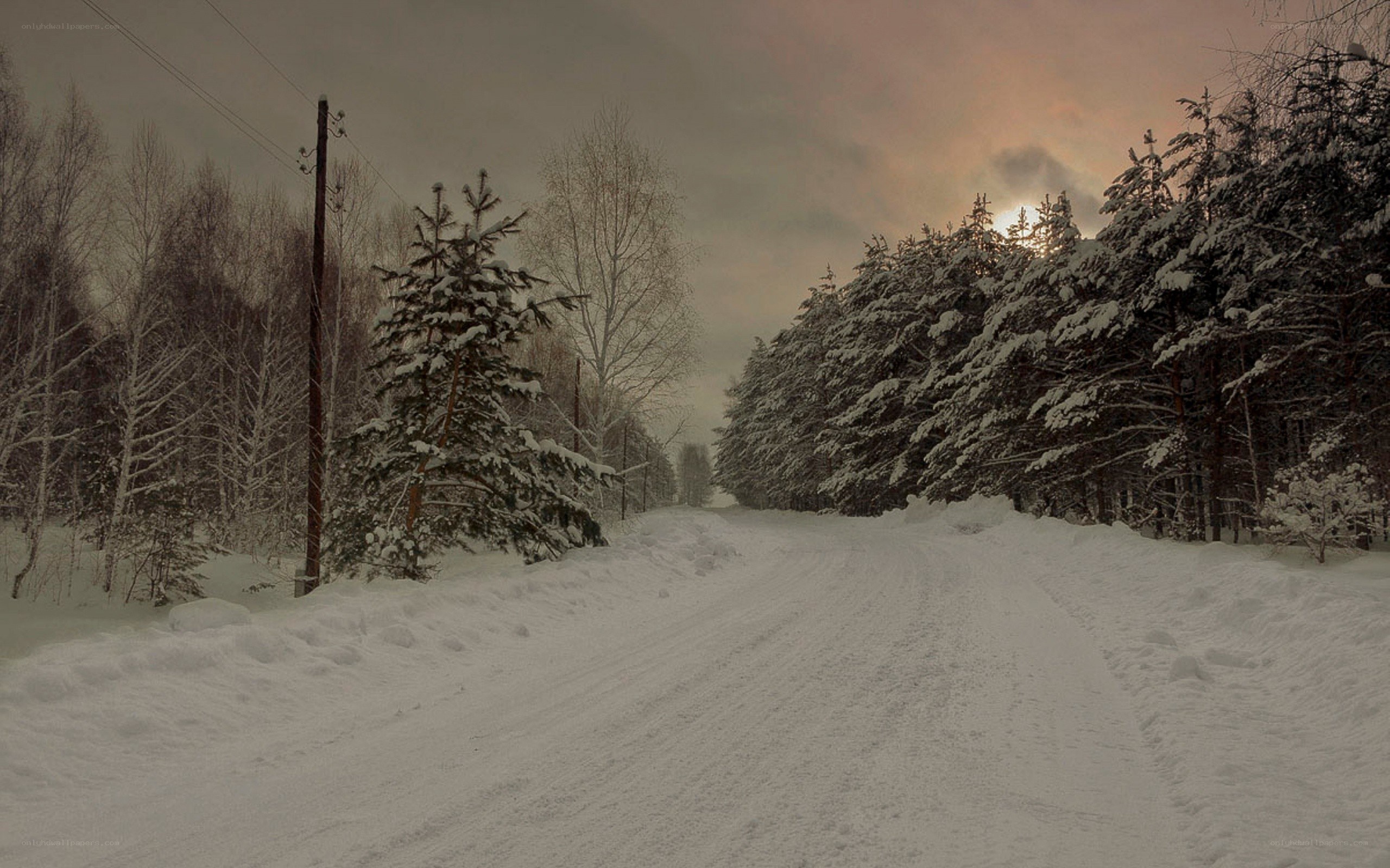 Snowy road at sunset