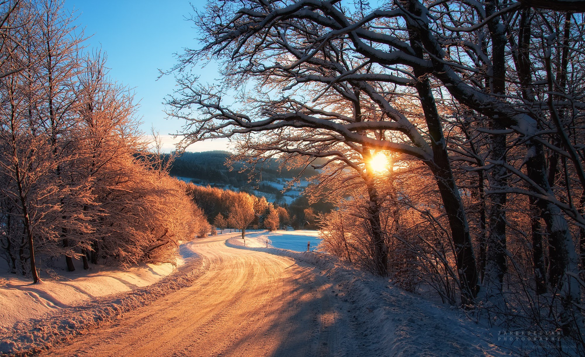 Snowy road at sunset