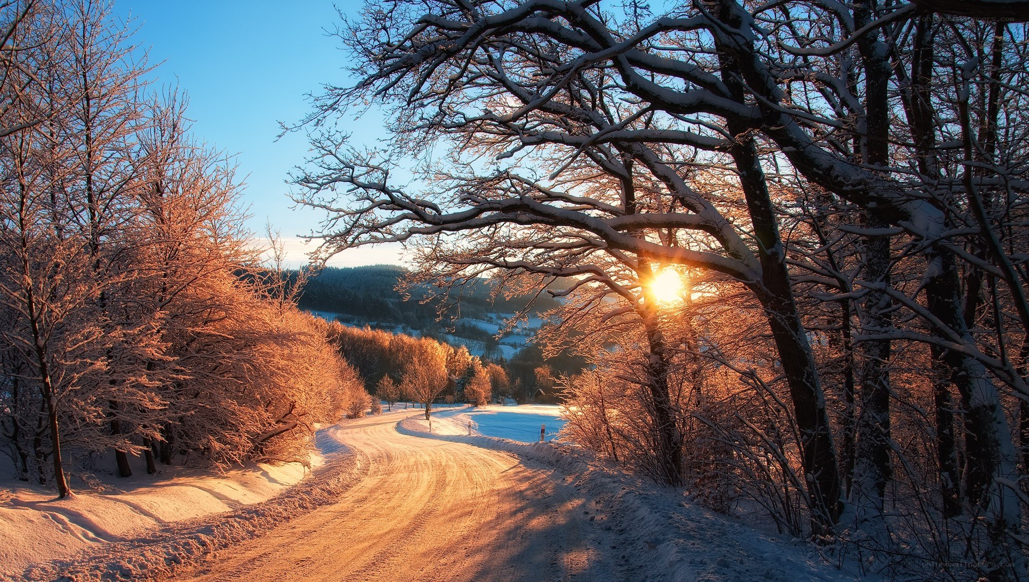 Snowy road at sunset