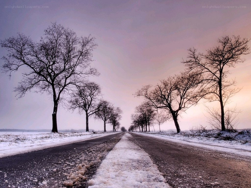 Snowy road at sunset