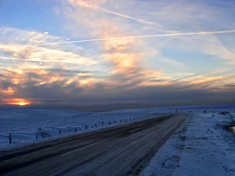 Snowy road at sunset