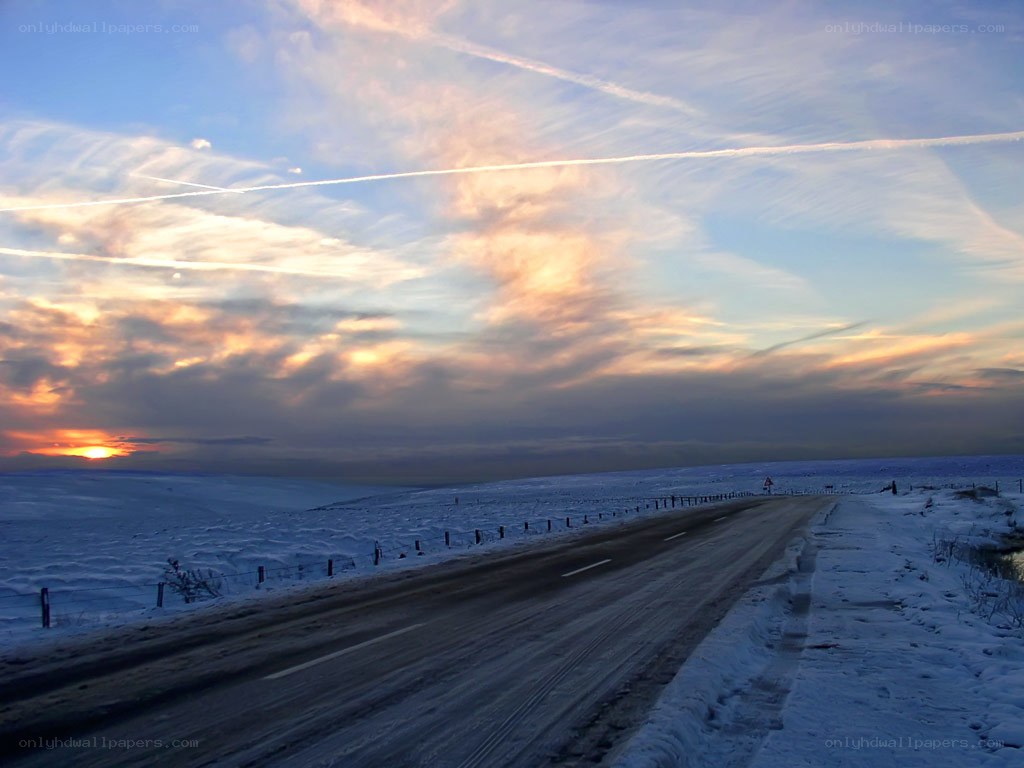 Snowy road at sunset