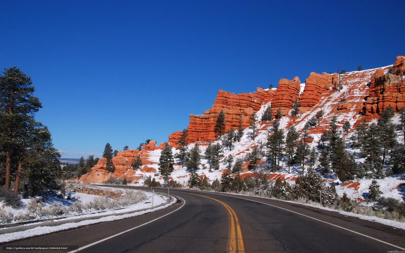 Snowy road through red rock canyon