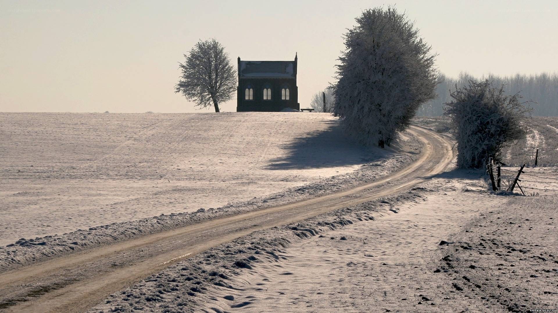 Snowy road to a chapel