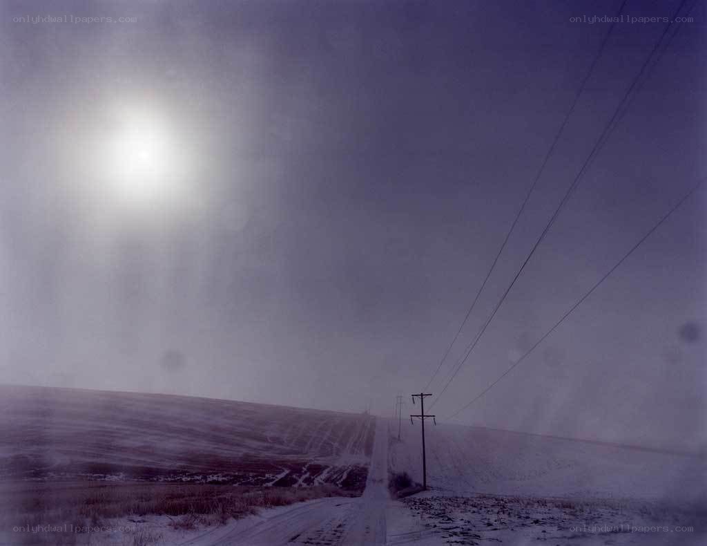 Snowy road under a bright sun