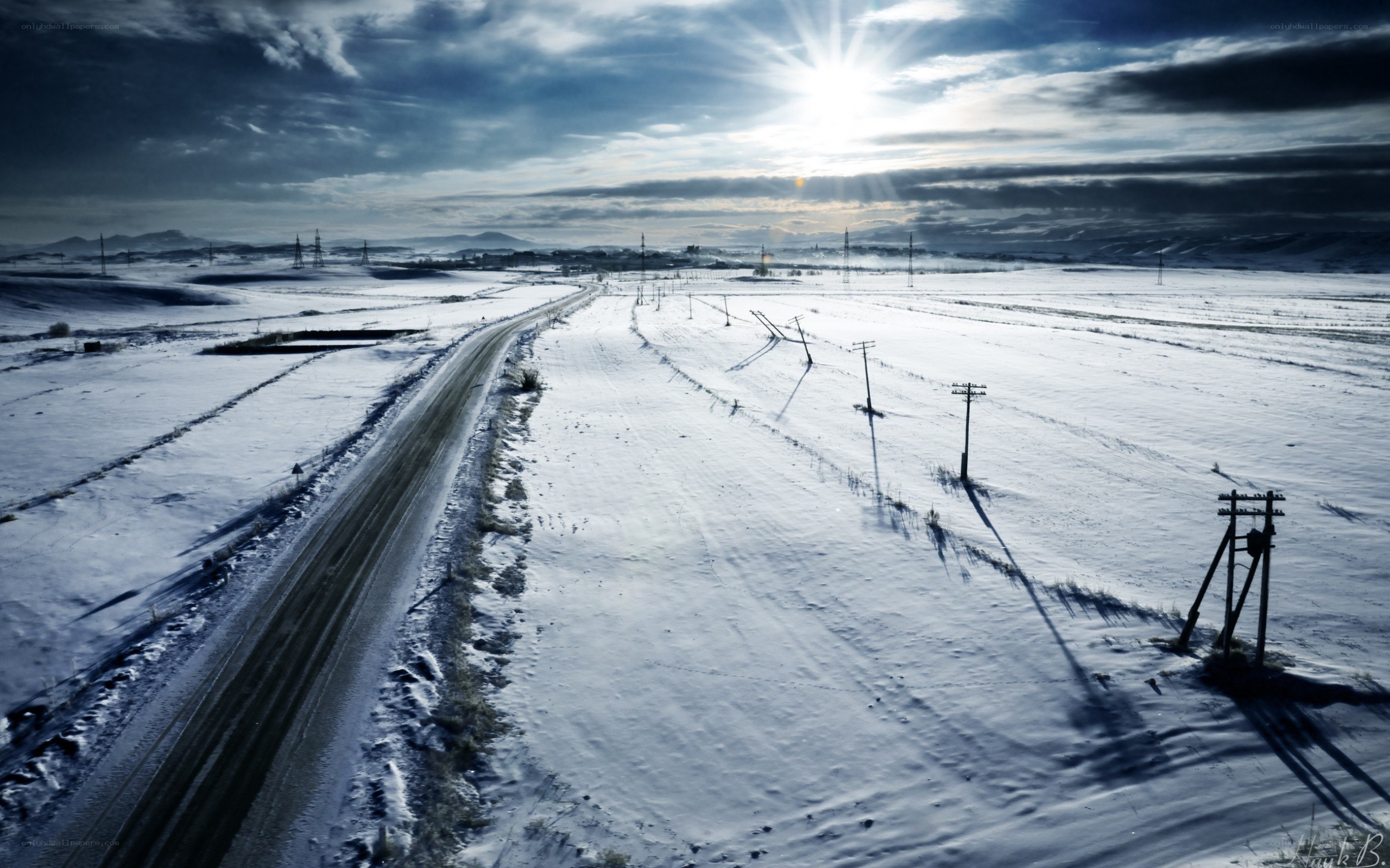 Snowy road under bright sun