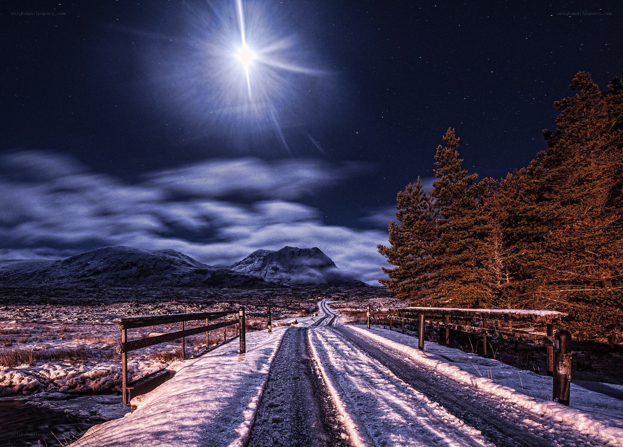 Snowy road under moonlight
