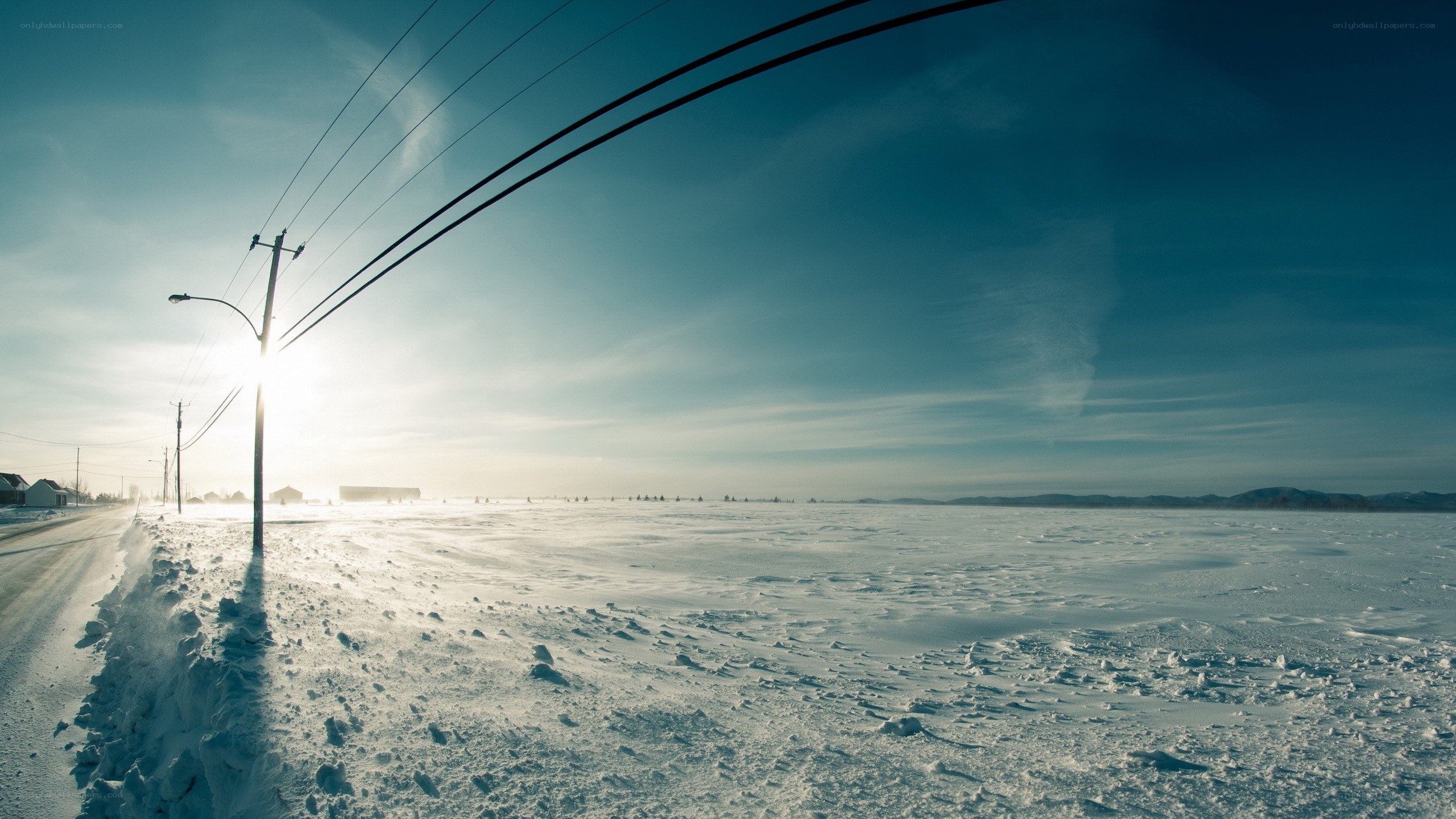 Snowy road under power lines