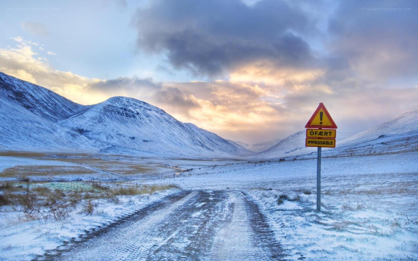 Snowy road with warning sign
