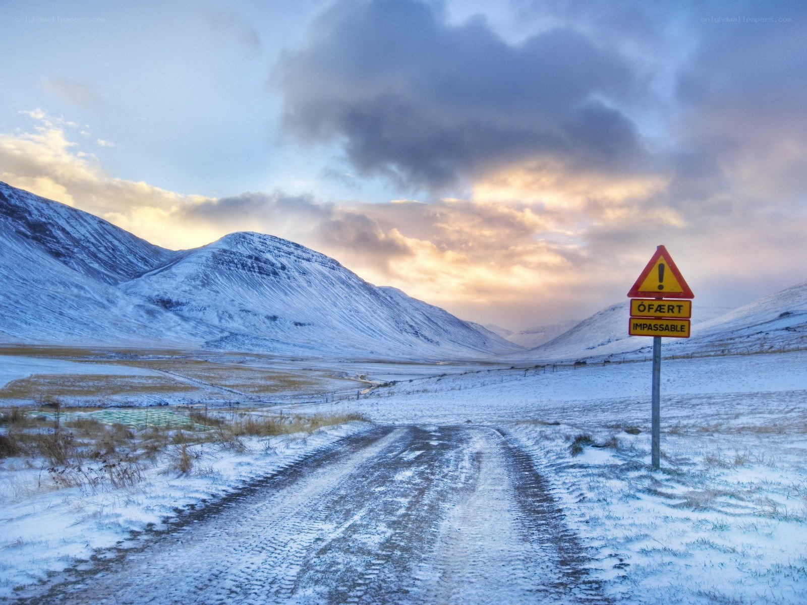 Snowy road with warning sign