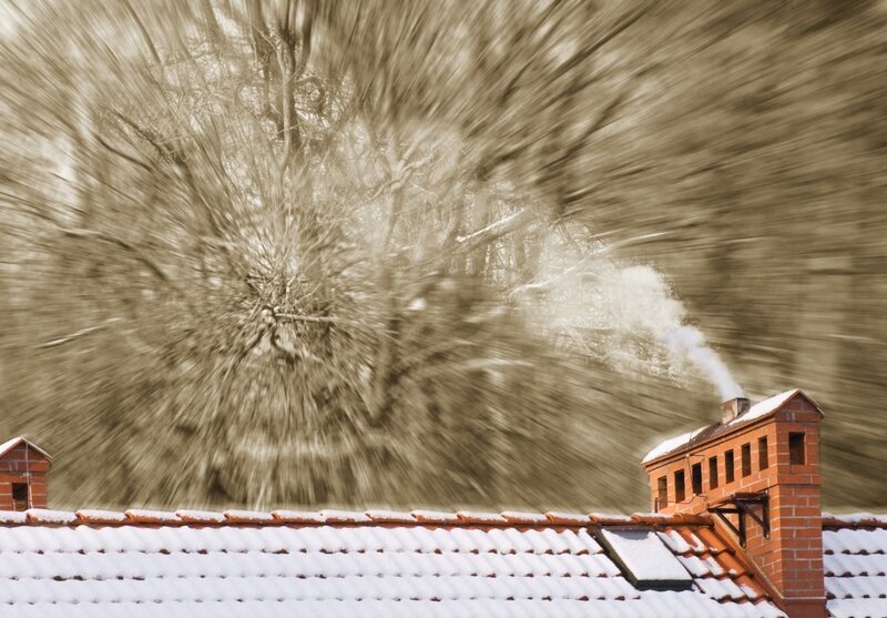Snowy roof with chimney smoke