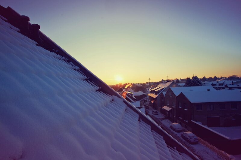 Snowy rooftop at sunset
