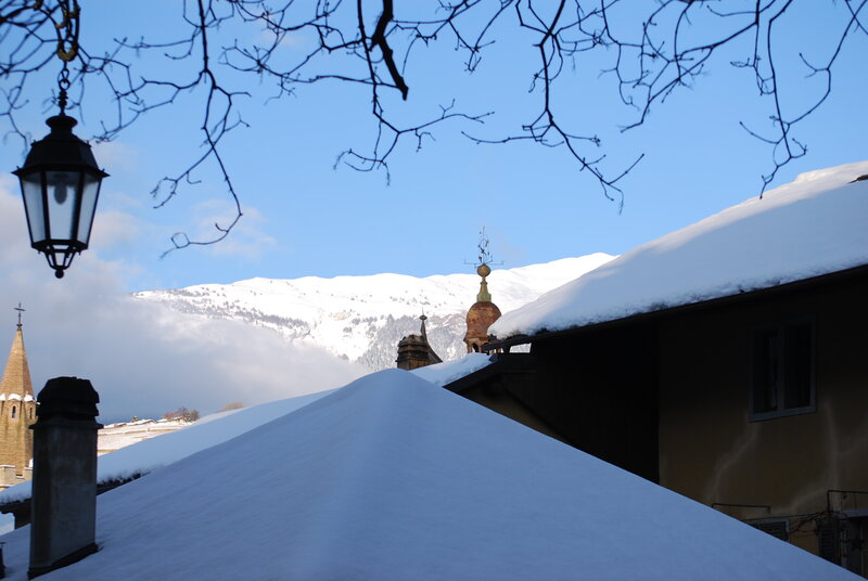 Snowy rooftops with mountain view