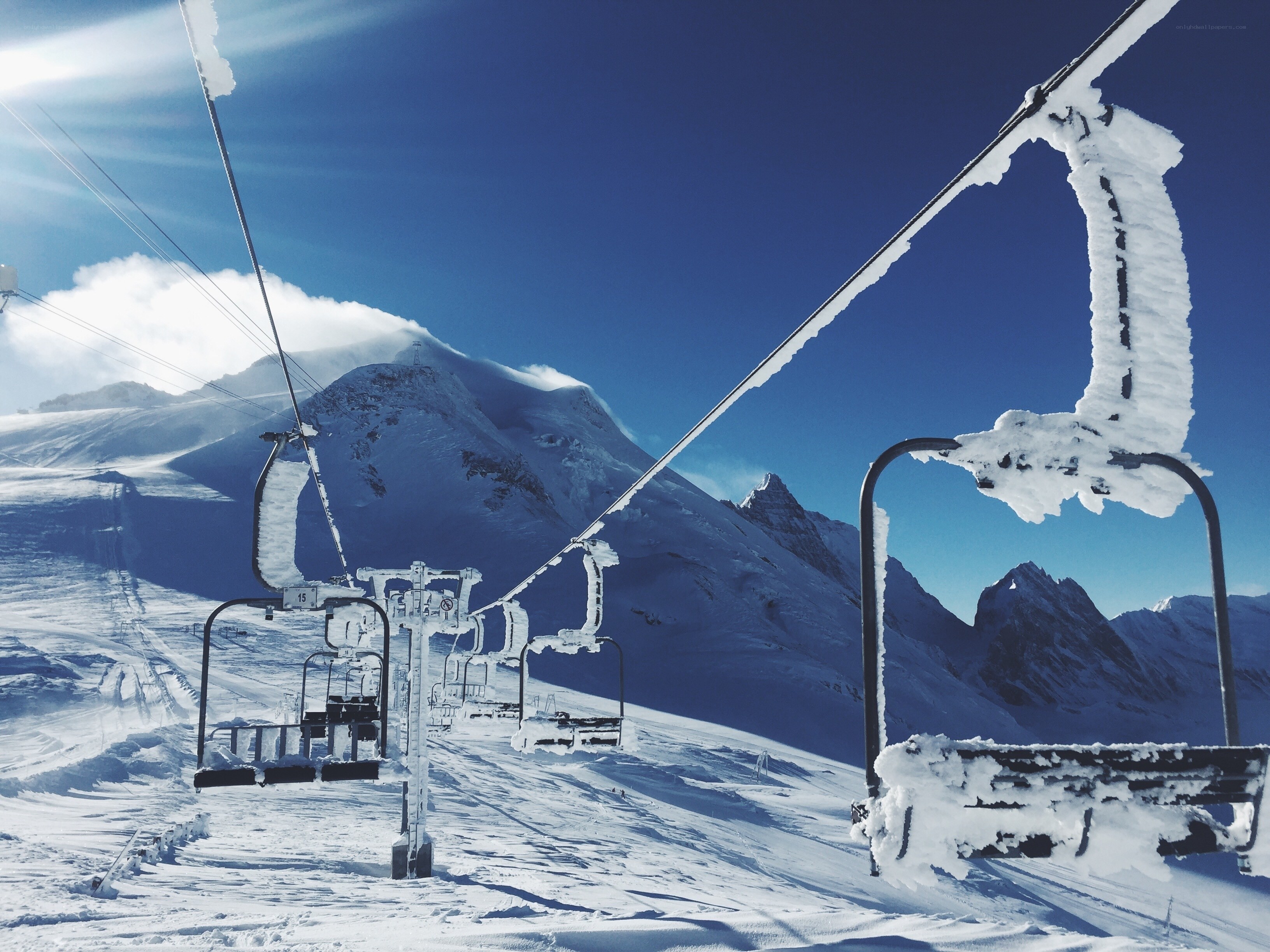 Snowy ski lift with mountain view