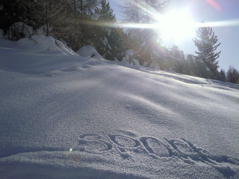 Snowy slope with sun glare