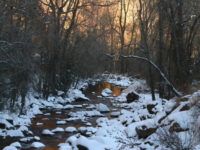 Snowy stream at sunset