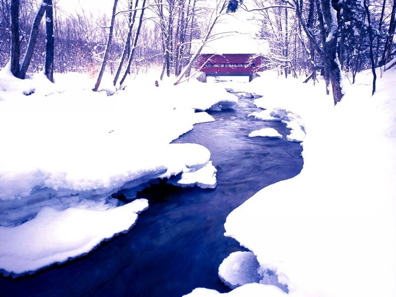 Snowy stream with covered bridge