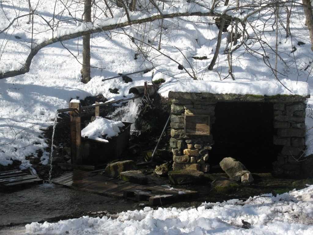 Snowy stream with stone structure