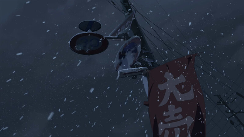 snowy street sign at night